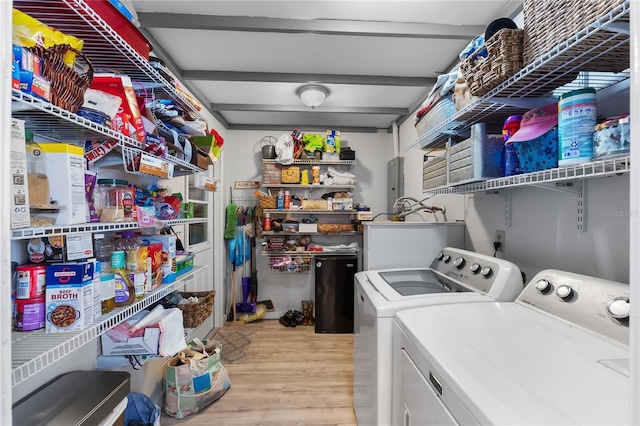 washroom with laundry area, washer and clothes dryer, and light wood-style floors