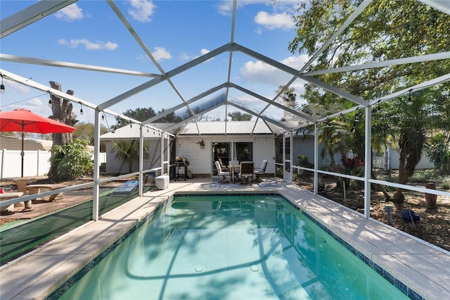 pool with a lanai, a patio, and fence