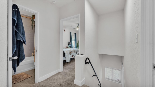 hallway featuring carpet, visible vents, and baseboards