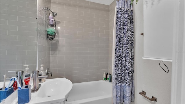 full bathroom with a sink and shower / bath combo with shower curtain