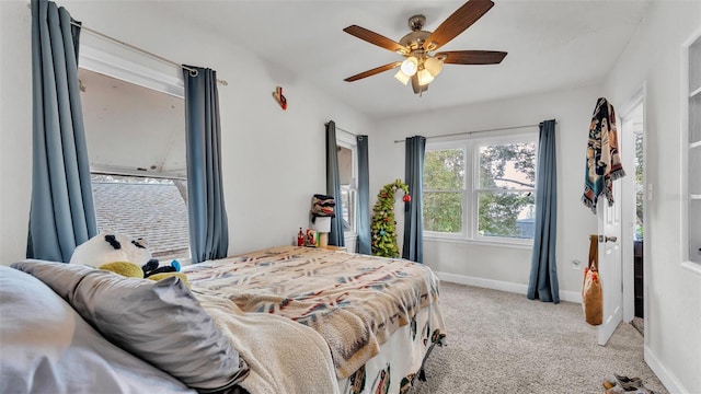 carpeted bedroom featuring ceiling fan and baseboards