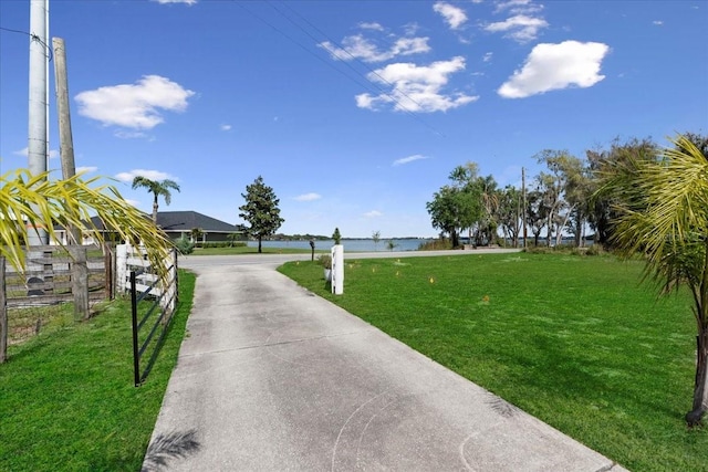 view of road with concrete driveway and a gated entry