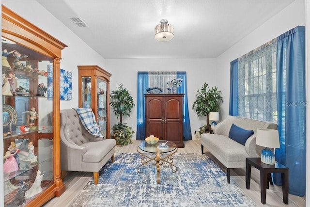 sitting room featuring visible vents and wood finished floors