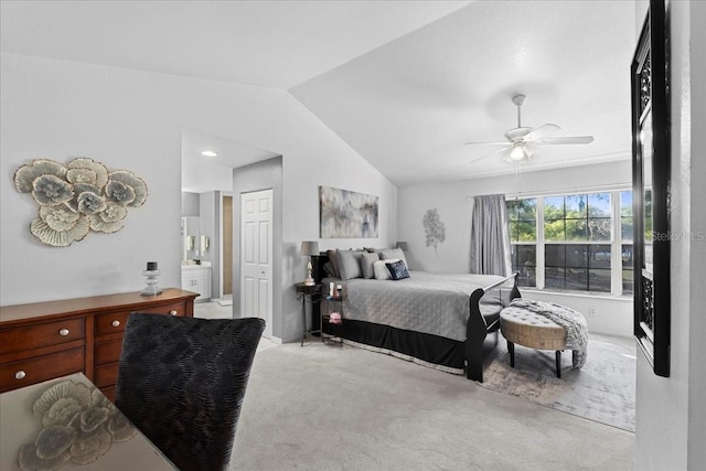 carpeted bedroom with lofted ceiling, a closet, connected bathroom, and ceiling fan