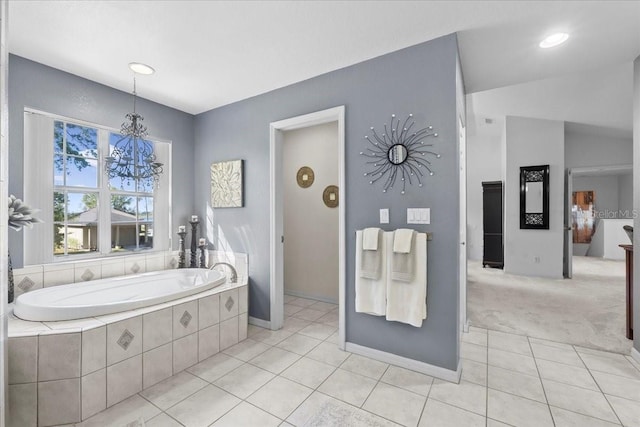 full bathroom featuring lofted ceiling, a garden tub, a notable chandelier, and tile patterned floors