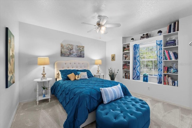 bedroom featuring a ceiling fan, carpet, a textured ceiling, and baseboards