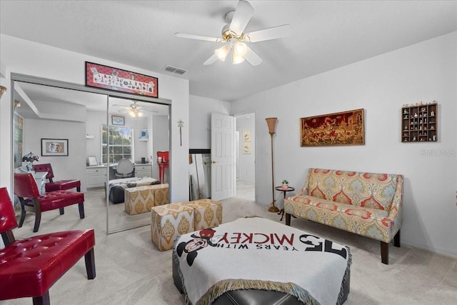 carpeted living room with ceiling fan and visible vents