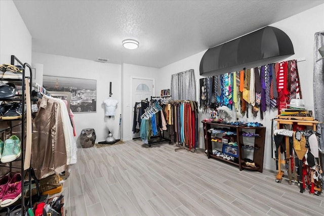 walk in closet featuring wood tiled floor and visible vents