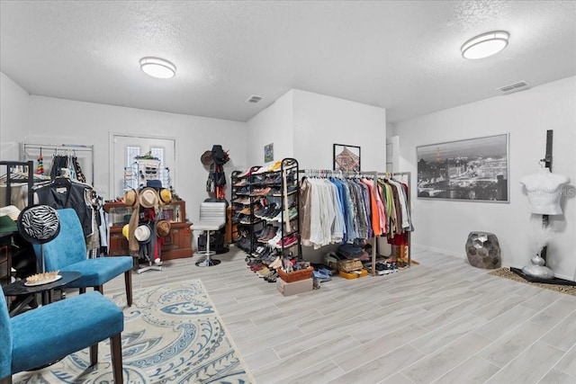 walk in closet featuring wood tiled floor and visible vents