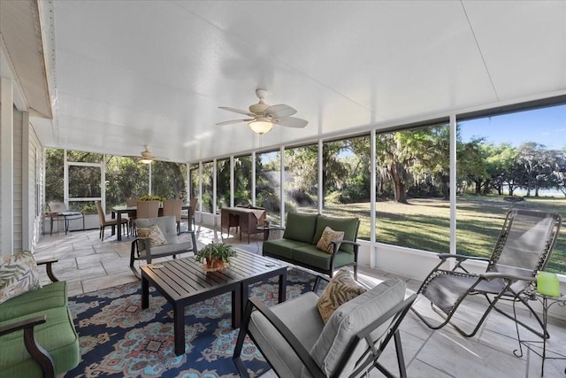 sunroom featuring a wealth of natural light and ceiling fan