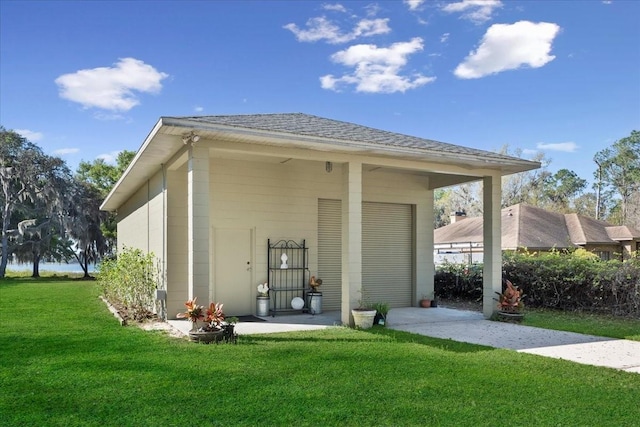 rear view of property with roof with shingles and a yard