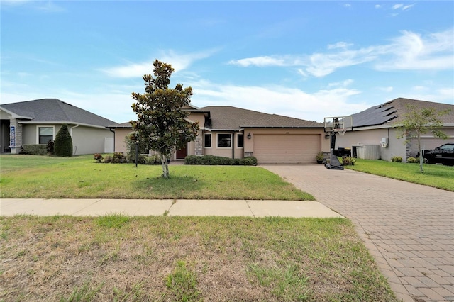 view of front of home featuring a garage, stucco siding, decorative driveway, and a front yard