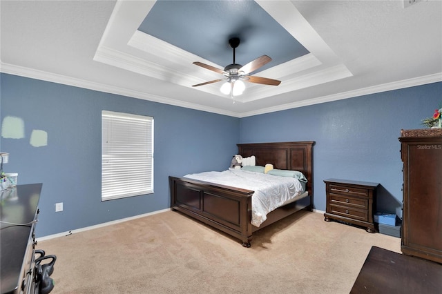 bedroom with carpet floors, crown molding, a raised ceiling, ceiling fan, and baseboards