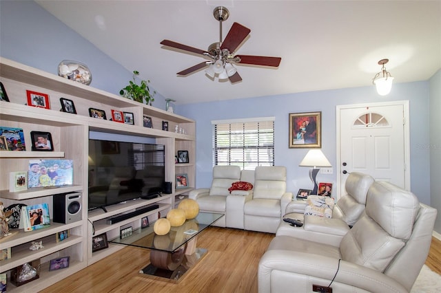 living room featuring a ceiling fan, vaulted ceiling, and wood finished floors