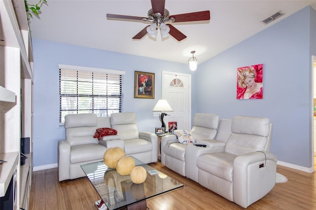 living room with visible vents, baseboards, wood finished floors, and a ceiling fan