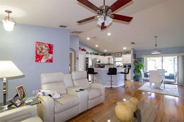 living area with vaulted ceiling, light wood-style flooring, recessed lighting, and visible vents