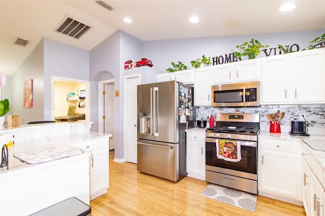 kitchen featuring visible vents, white cabinetry, and stainless steel appliances