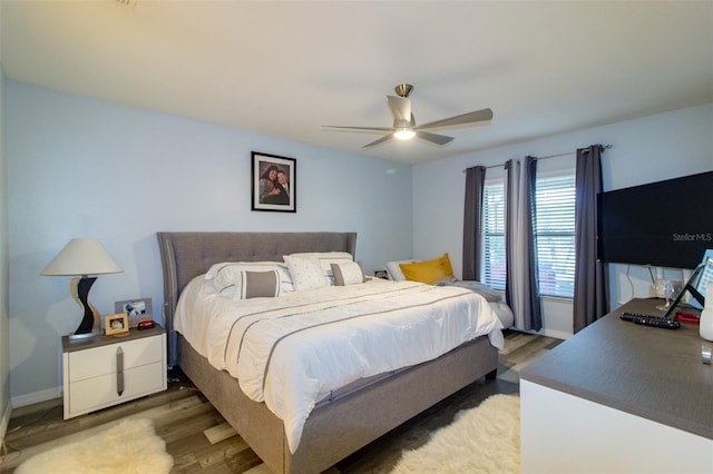 bedroom with ceiling fan, light wood-type flooring, and baseboards