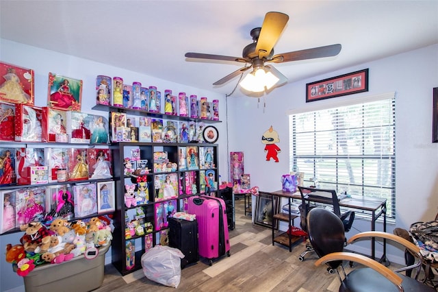 home office with wood finished floors and ceiling fan