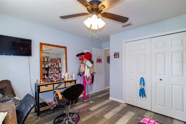 office featuring a ceiling fan, wood finished floors, and visible vents