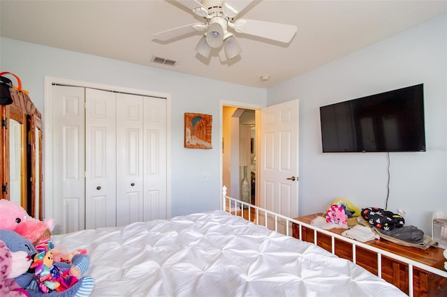 bedroom with a closet, visible vents, and a ceiling fan