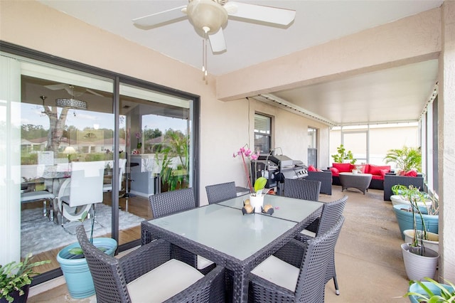 sunroom with a healthy amount of sunlight and ceiling fan