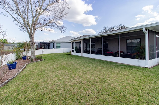 view of yard featuring a fenced backyard and a sunroom