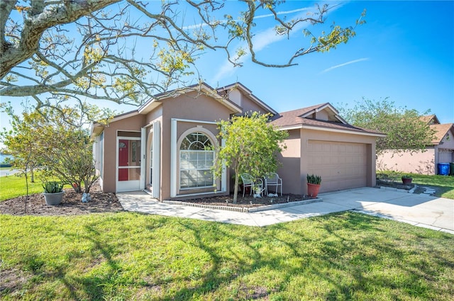 ranch-style house featuring driveway, an attached garage, a front yard, and stucco siding