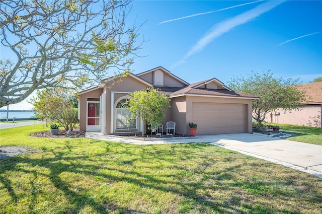 view of front facade with a garage, concrete driveway, roof with shingles, stucco siding, and a front yard