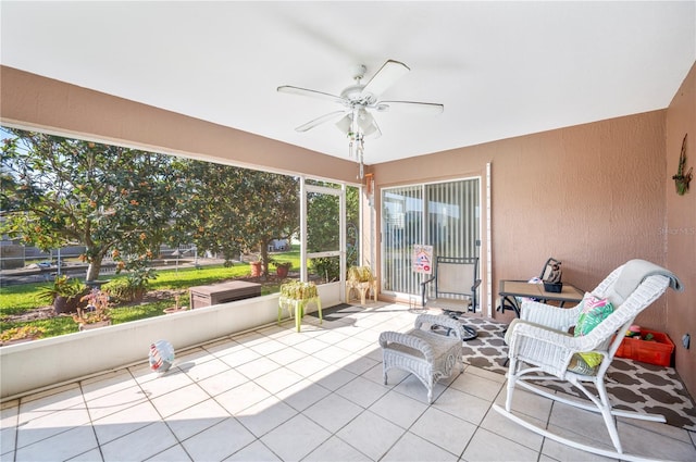 sunroom featuring a ceiling fan