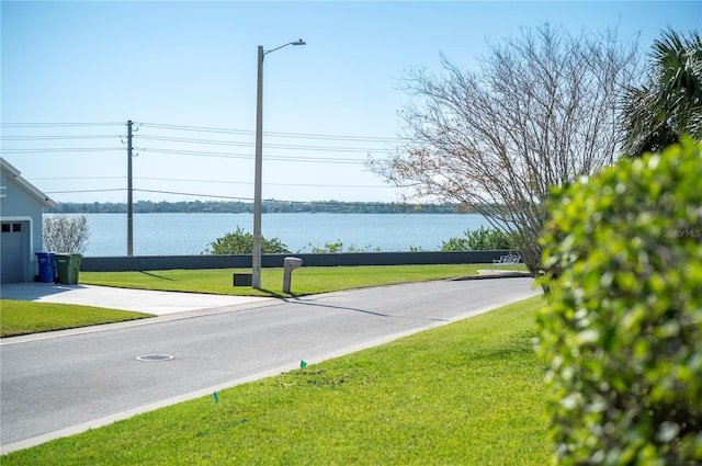 view of street with street lights and a water view