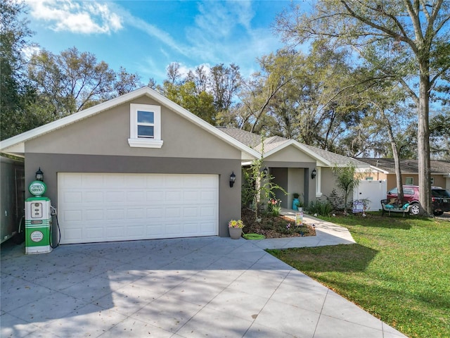 ranch-style home featuring a garage, driveway, a front lawn, and stucco siding