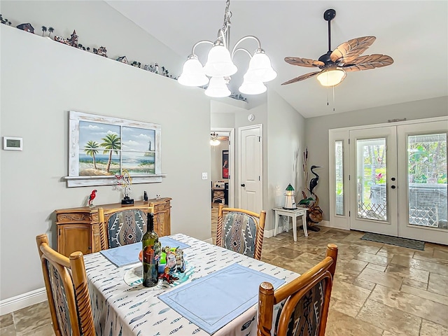 dining room with lofted ceiling, stone tile floors, a ceiling fan, baseboards, and french doors