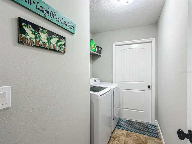 laundry room with stone finish floor, a textured ceiling, separate washer and dryer, laundry area, and baseboards