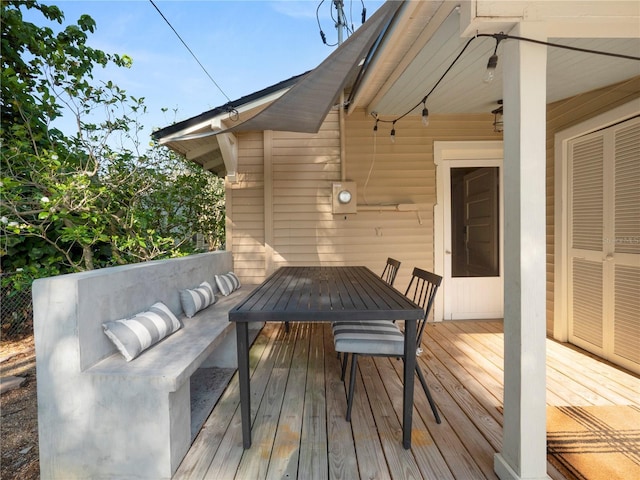 wooden terrace with outdoor dining space