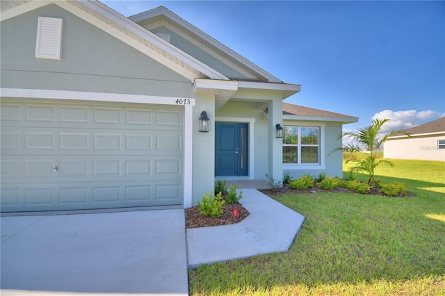 view of front of home featuring a garage, a front yard, concrete driveway, and stucco siding