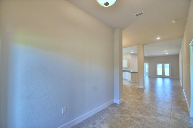 hallway featuring french doors, recessed lighting, visible vents, and baseboards