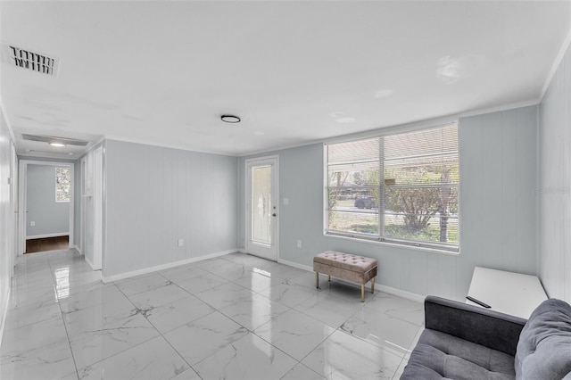 unfurnished living room with marble finish floor, visible vents, and baseboards