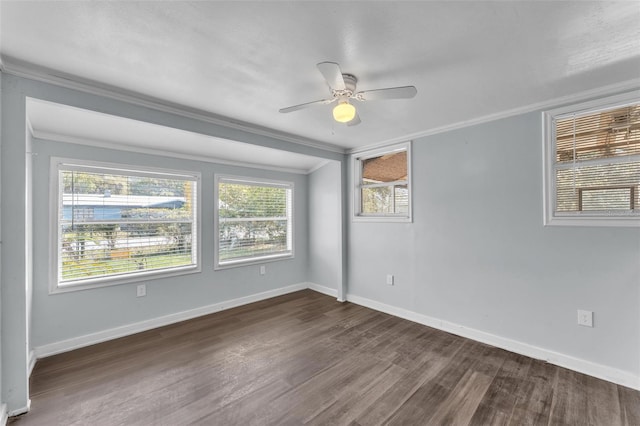 empty room featuring ceiling fan, ornamental molding, wood finished floors, and baseboards