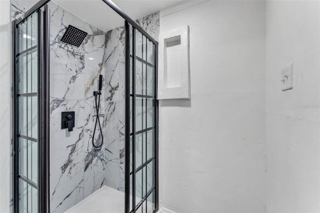 bathroom with a marble finish shower