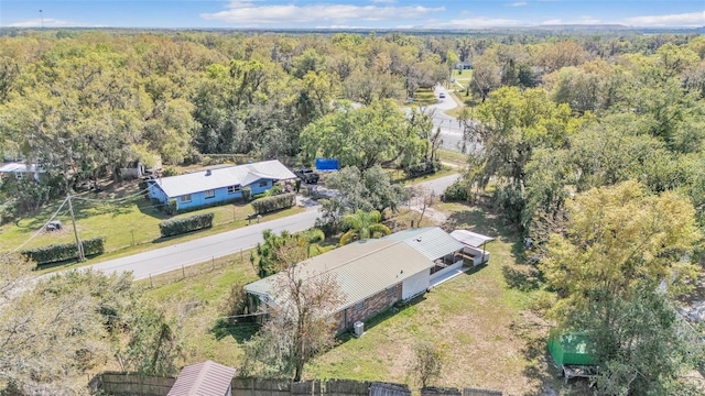 drone / aerial view with a wooded view