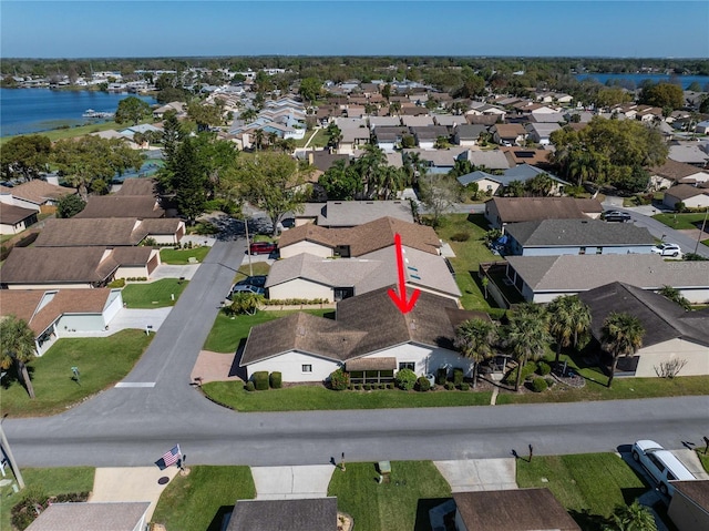 bird's eye view featuring a water view and a residential view