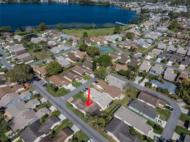 drone / aerial view featuring a water view and a residential view