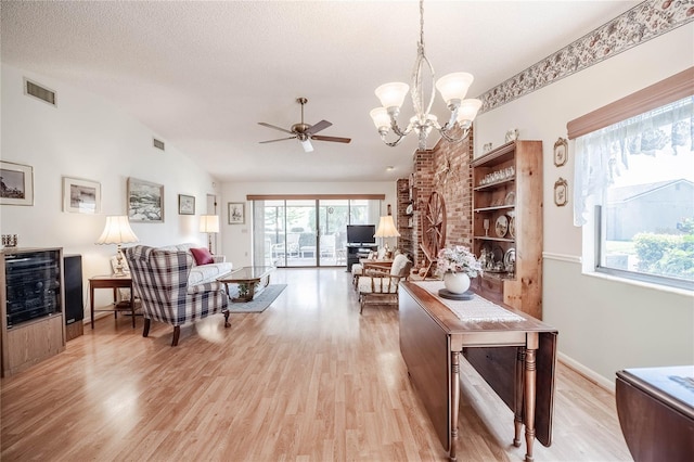 interior space with lofted ceiling, light wood-type flooring, and visible vents