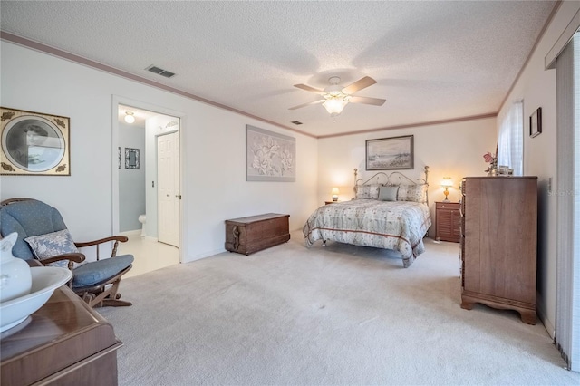 bedroom featuring light carpet, ornamental molding, and a textured ceiling