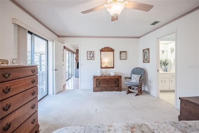 sitting room with a textured ceiling, visible vents, carpet flooring, and ornamental molding