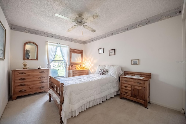 bedroom with light carpet, a textured ceiling, and a ceiling fan