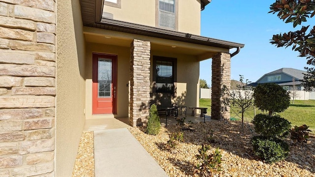 property entrance featuring stucco siding