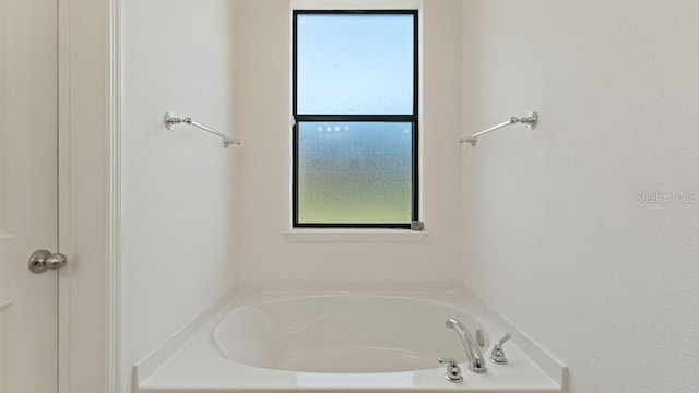 bathroom with a garden tub