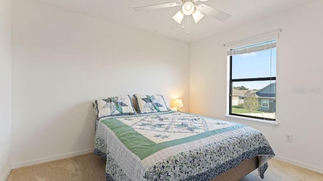 bedroom featuring carpet floors, a ceiling fan, and baseboards